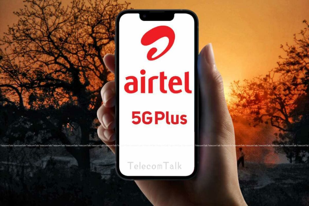 Hand holding phone with Airtel 5G Plus advertisement