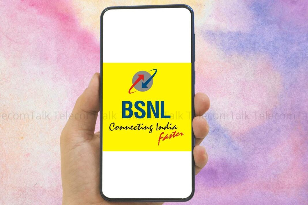 Hand holding smartphone displaying BSNL logo.