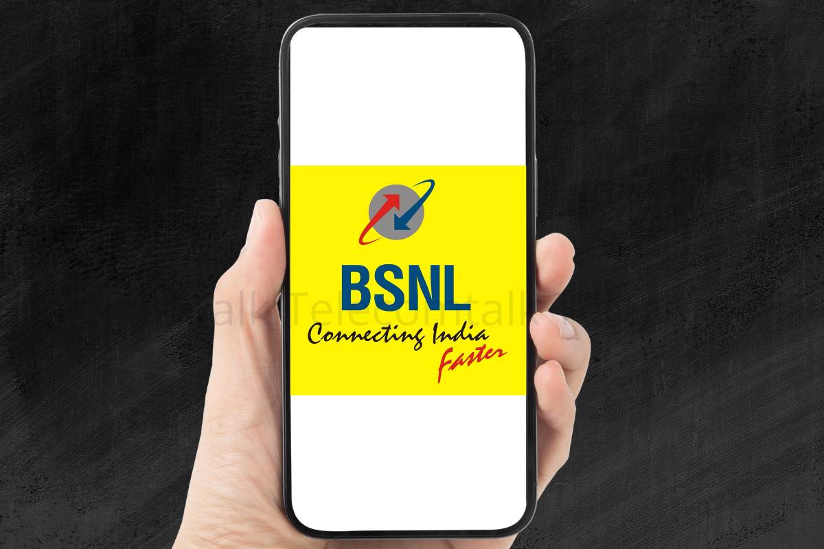 Hand holding smartphone with BSNL logo on screen.