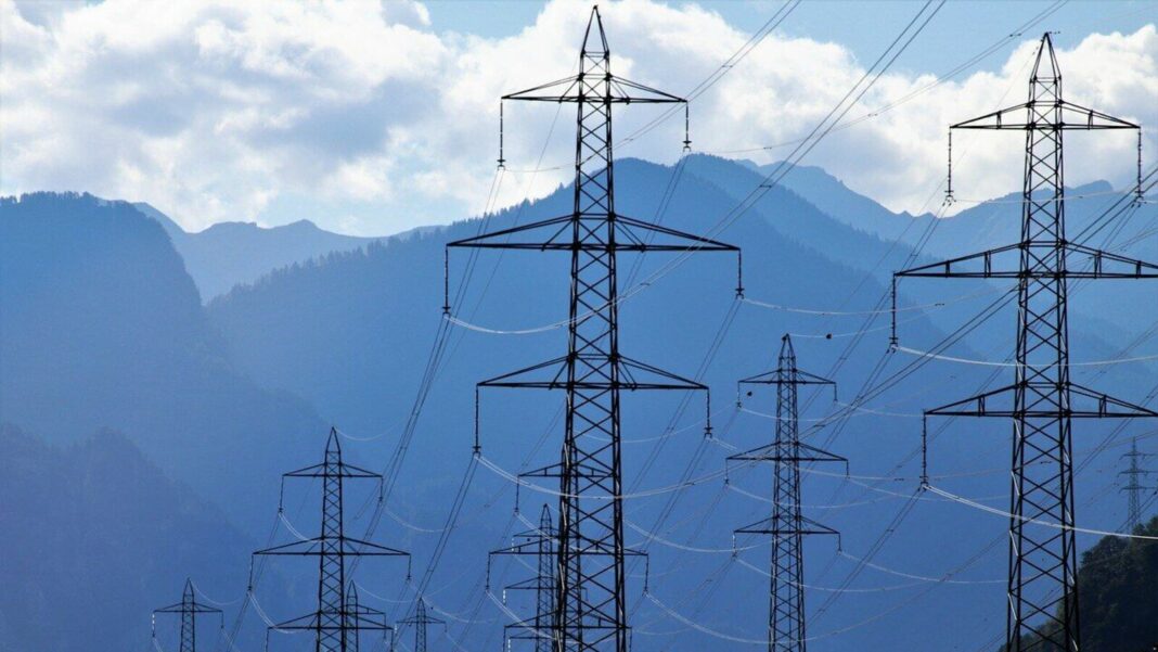 Power lines against mountainous backdrop.