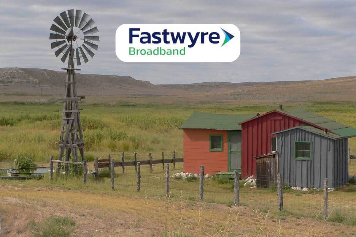 Rural scene with windmill, sheds, and Fastwyre Broadband logo.