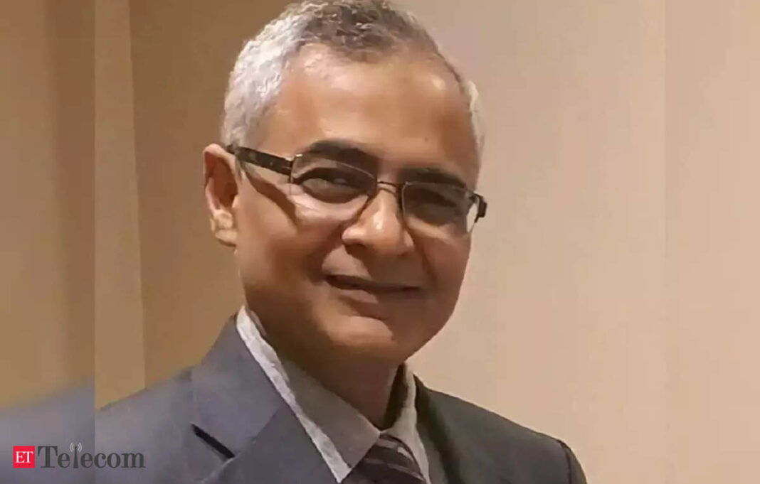 Smiling man with glasses in business attire.