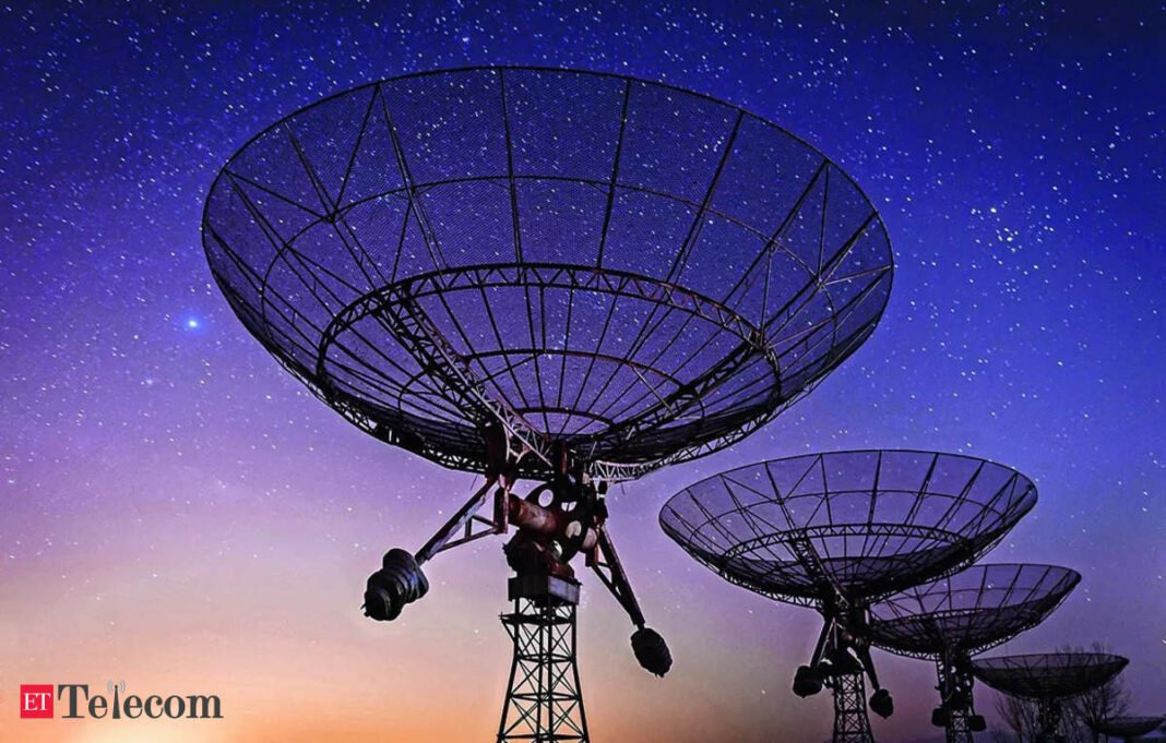 Radio telescopes under starry night sky.