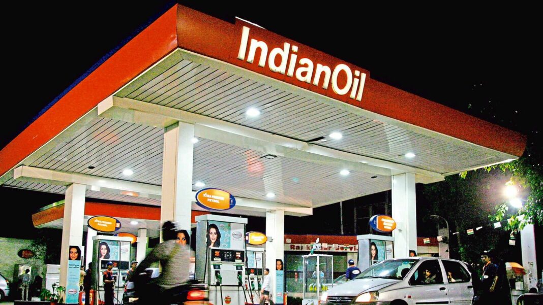 IndianOil gas station at night with customers.