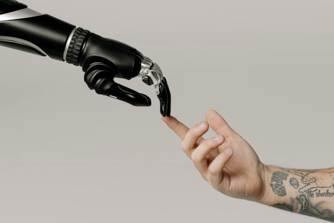 Robot hand touching human finger, concept of AI interaction.