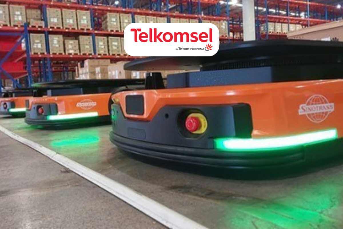 Autonomous warehouse robots with company logos in industrial setting.
