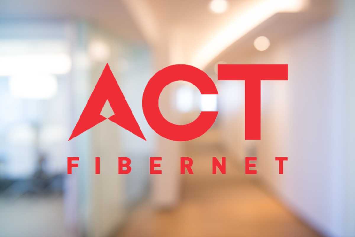ACT Fibernet logo on blurred office background