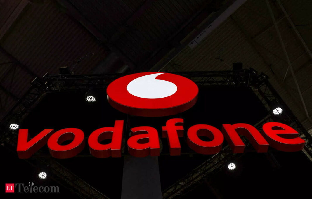 Vodafone logo on dark background at event.