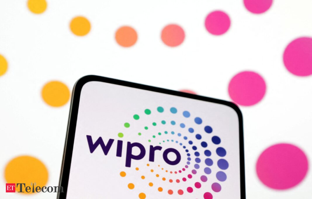 Wipro logo on digital tablet with colorful dots background.