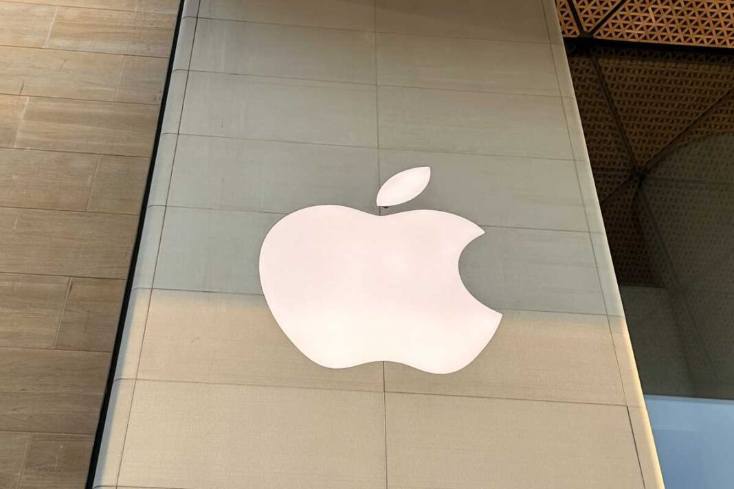 Apple logo on store exterior wall.