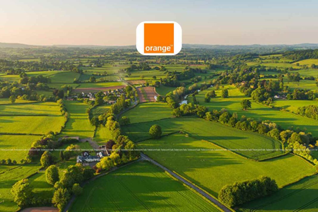 Aerial view of lush green countryside with logo overlay.