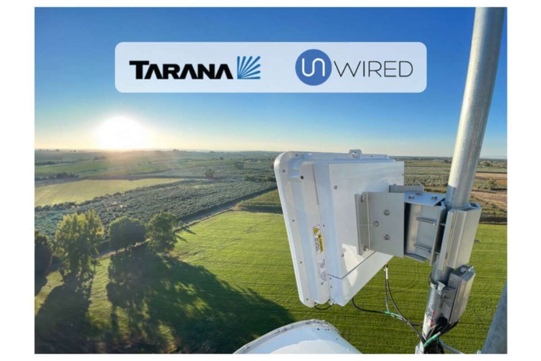 Wireless network equipment on a rural tower at sunrise.