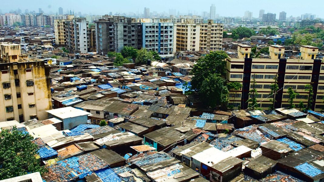 Urban contrast: crowded slum and high-rise buildings.