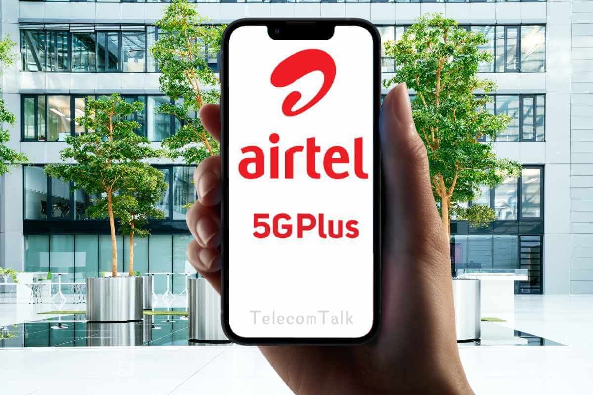 Hand holding smartphone displaying Airtel 5G Plus ad