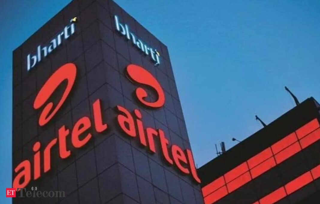 Airtel logo on building at twilight.