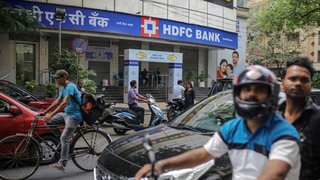 HDFC Bank exterior with passing traffic and pedestrians.