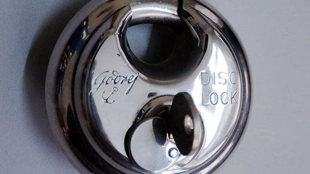 Close-up of a shiny disc padlock.