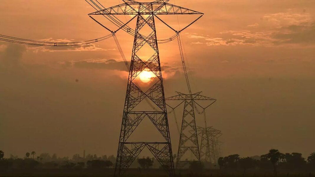 Sunset and silhouette of electricity pylons.