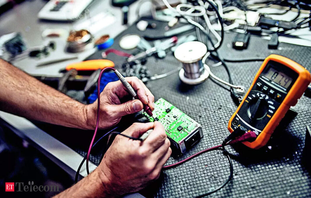 Person soldering on a circuit board with multimeter.