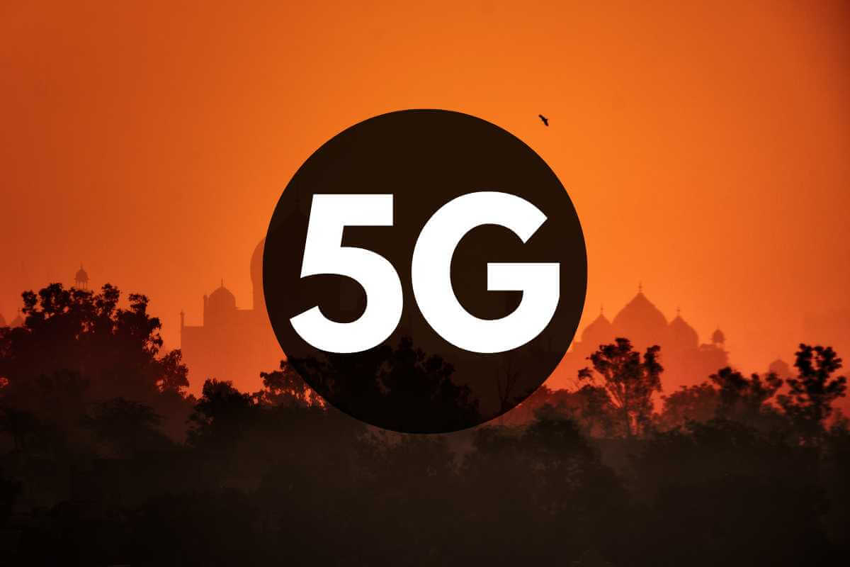 5G logo over orange sunset silhouette landscape.