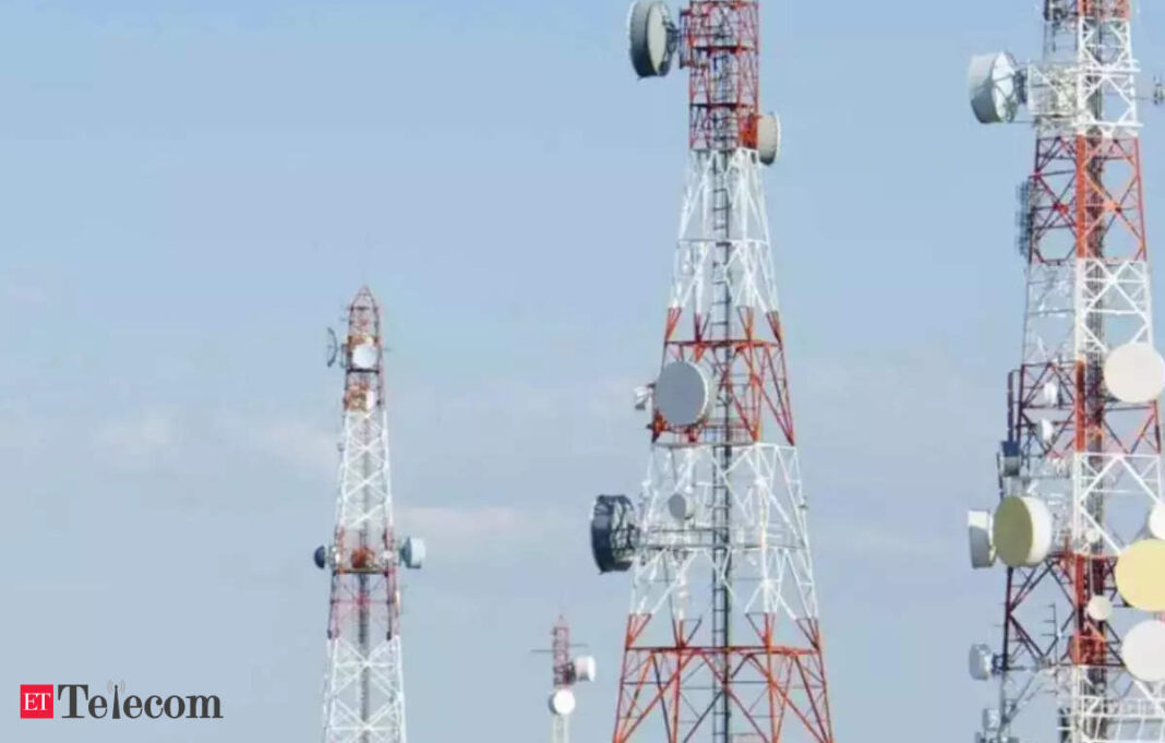 Cell towers against clear blue sky