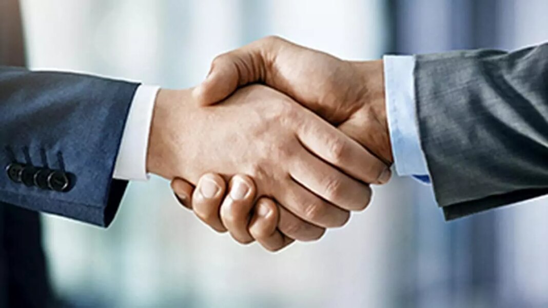 Two businesspeople shaking hands in agreement.