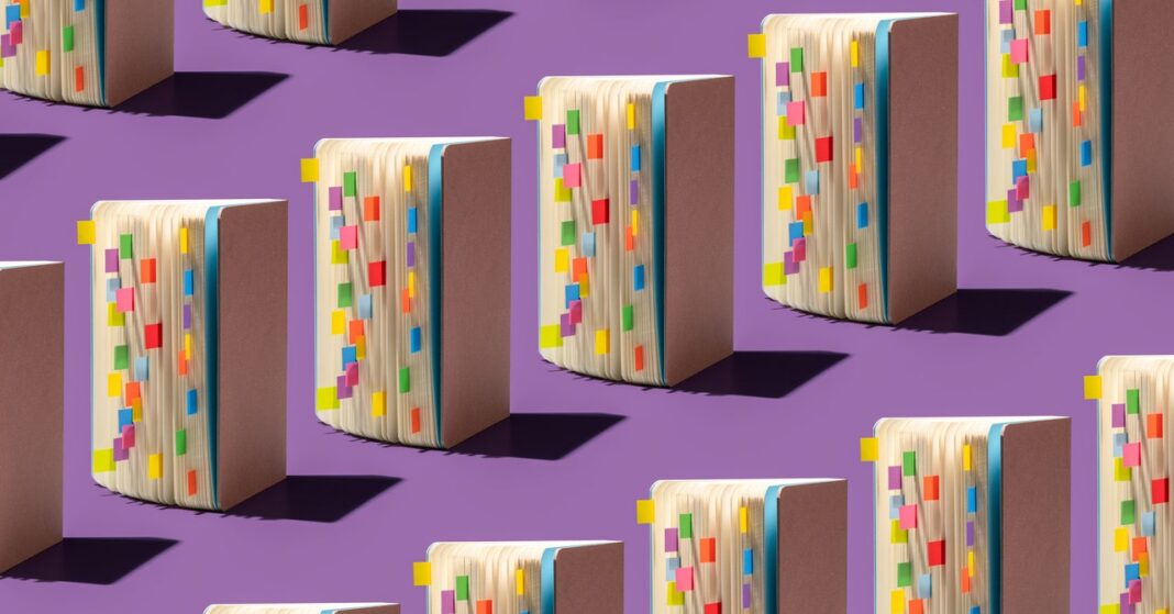 Books with colorful tabs on purple background