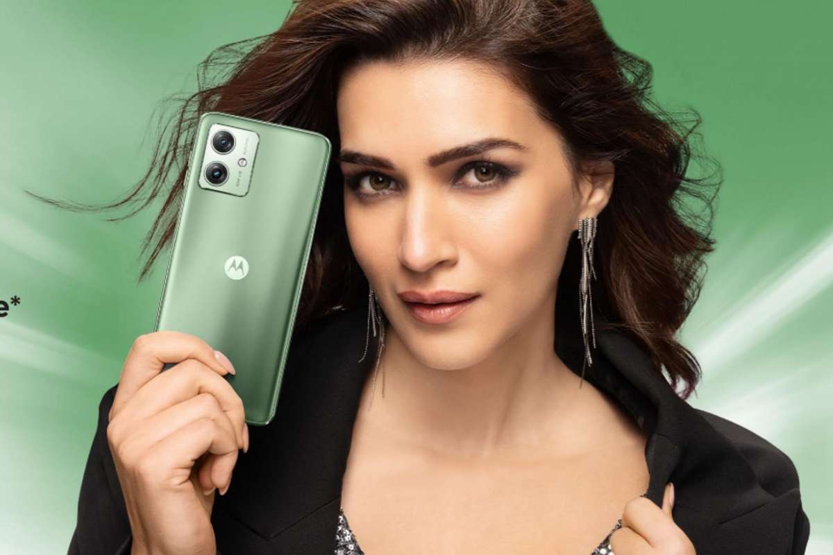 Woman posing with Motorola smartphone.
