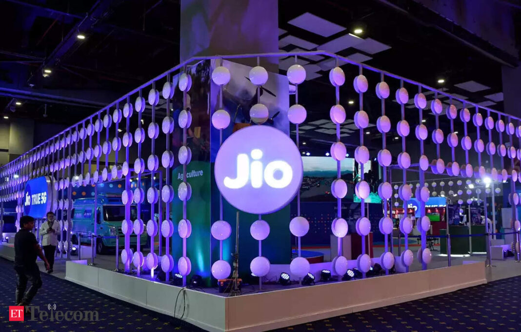 Jio exhibit with illuminated branding and spherical lights.