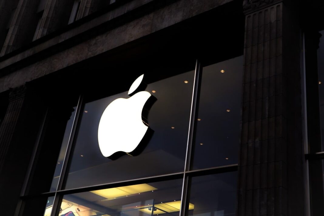 Apple logo on store facade at night