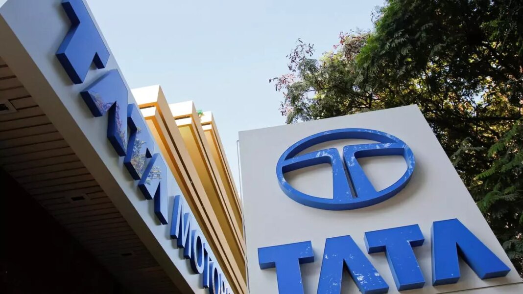 Tata Motors signboard with logo and trees.