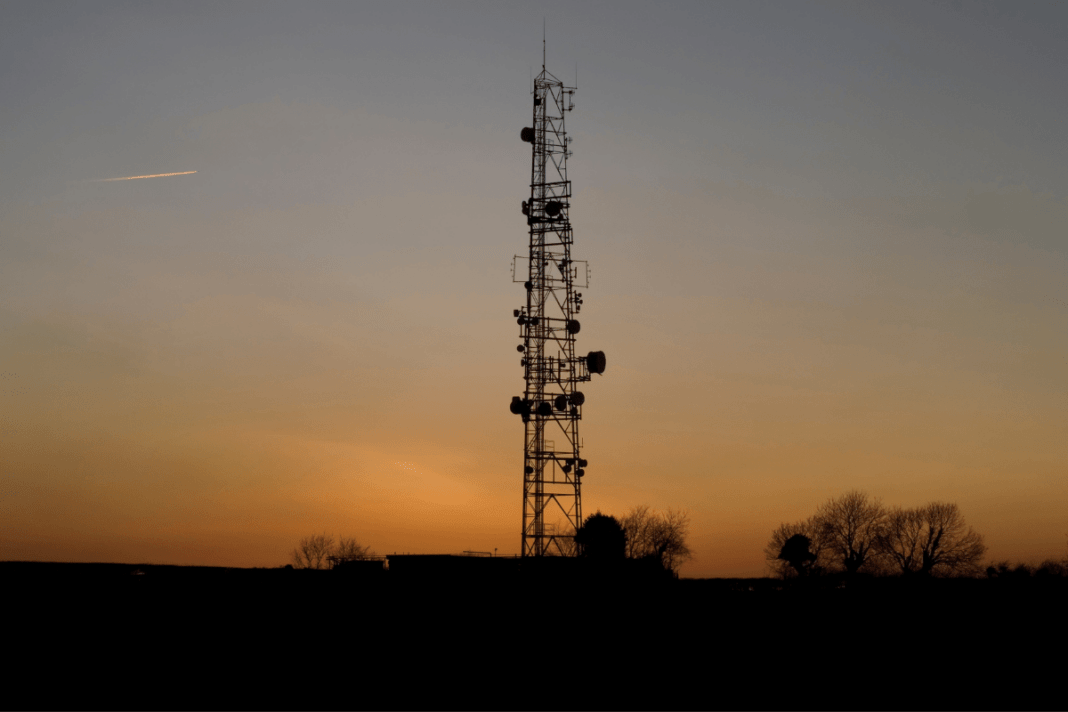 Communication tower silhouette at sunset.