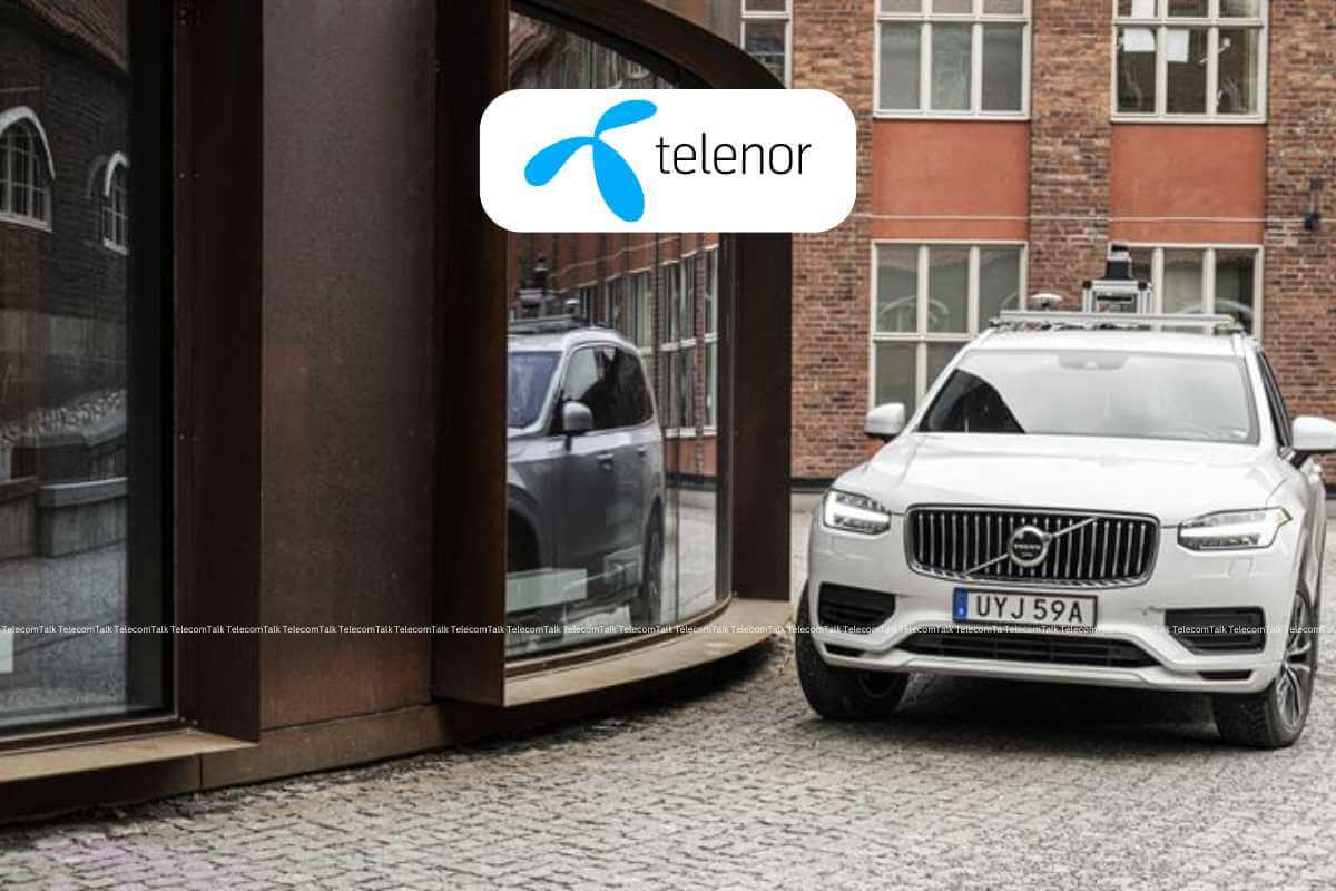 Telenor logo on building with Volvo car outside