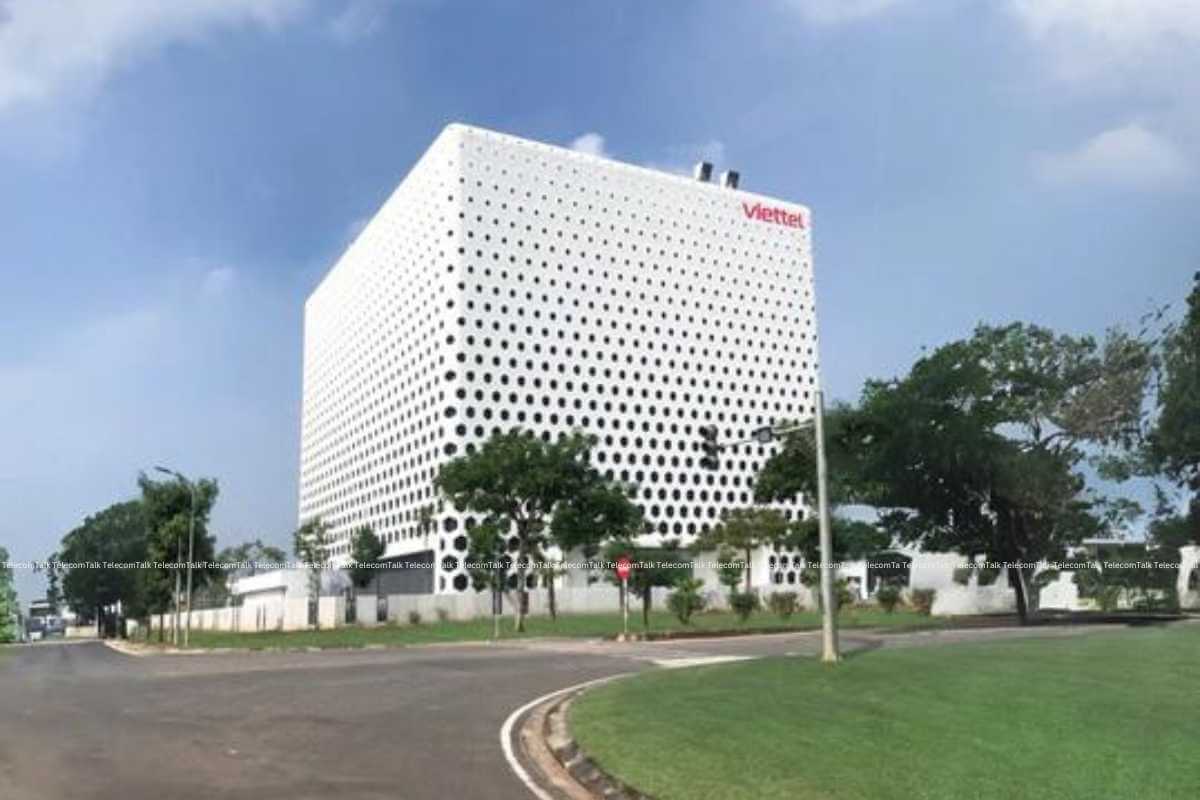 Modern building with perforated facade and company logo.