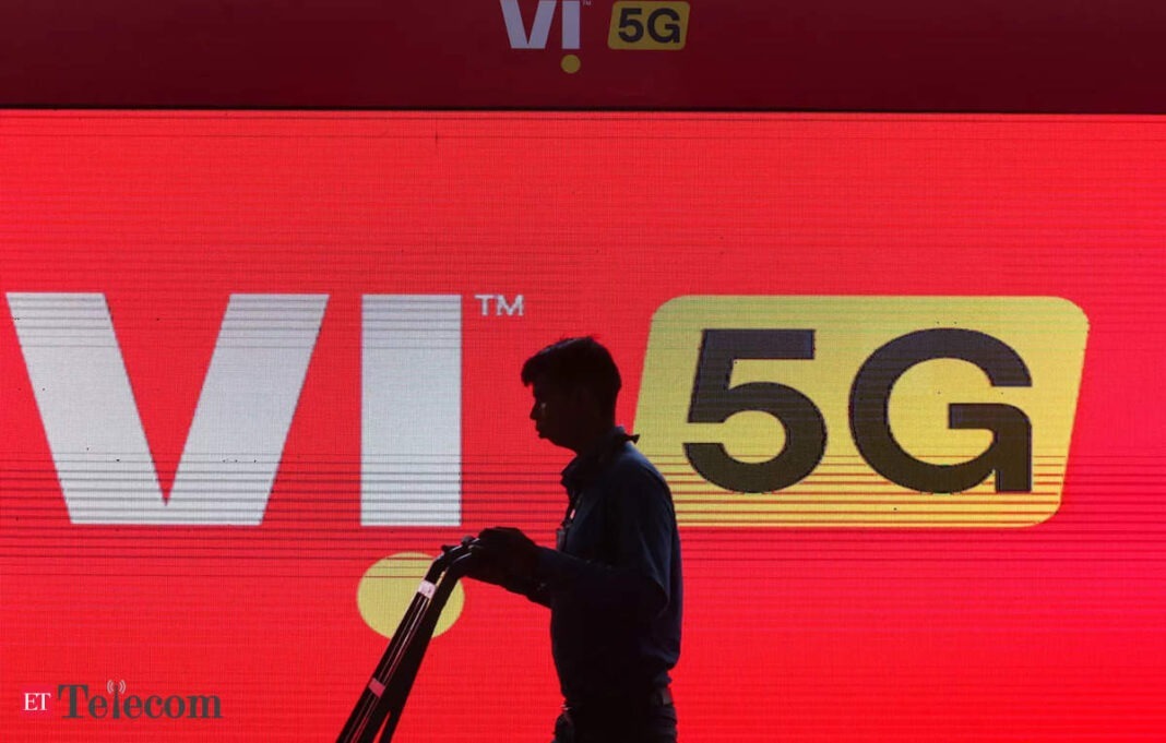 Man silhouetted against 5G telecom advertisement board.