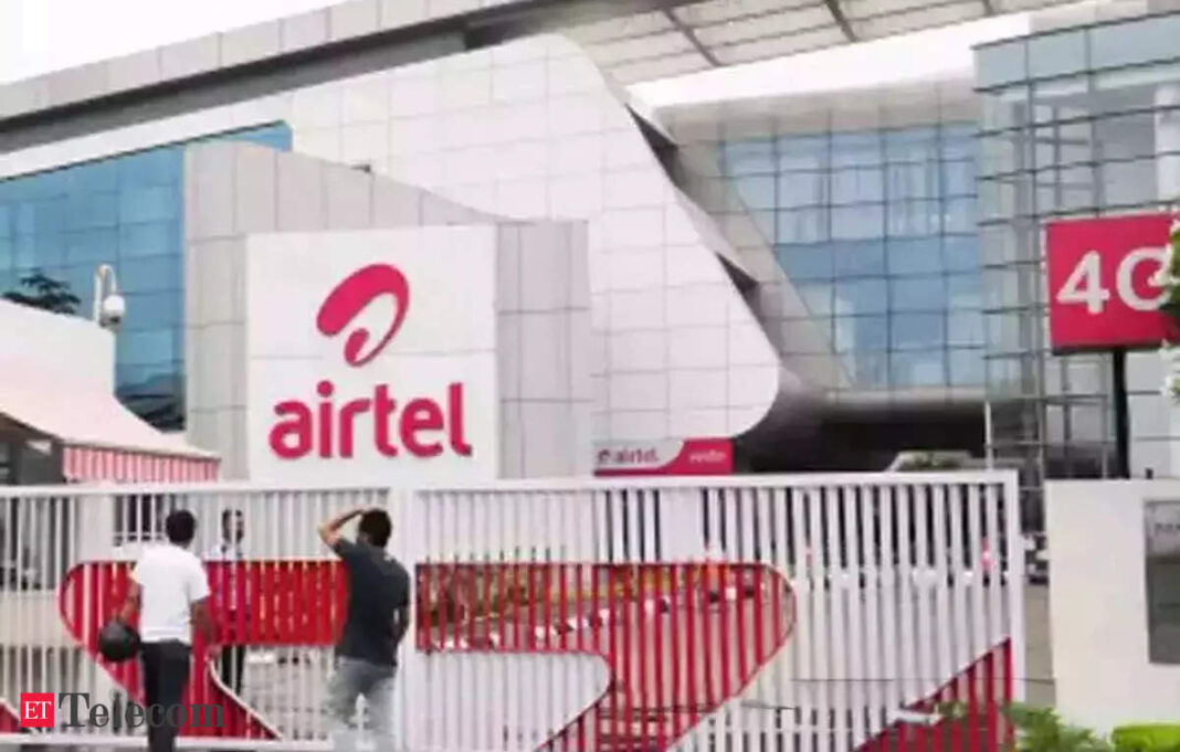 Airtel office building entrance with people and signage.