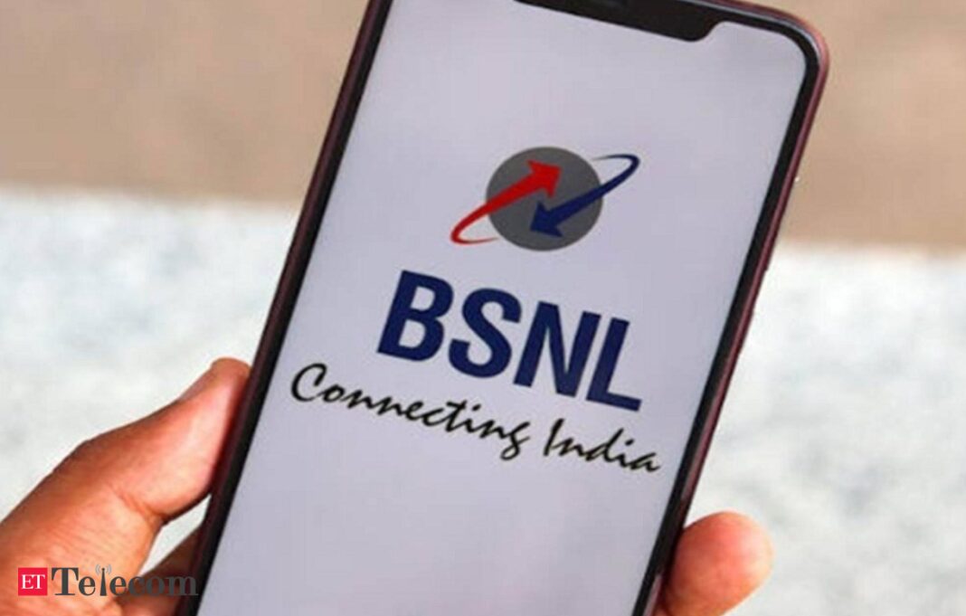 Hand holding phone with BSNL logo displayed.