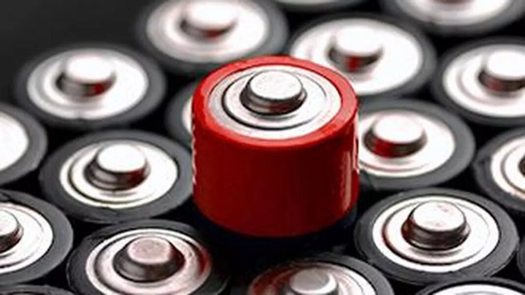 Red battery among black and silver button cells.