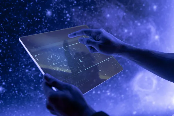 Person using futuristic transparent touchscreen device with holograms.