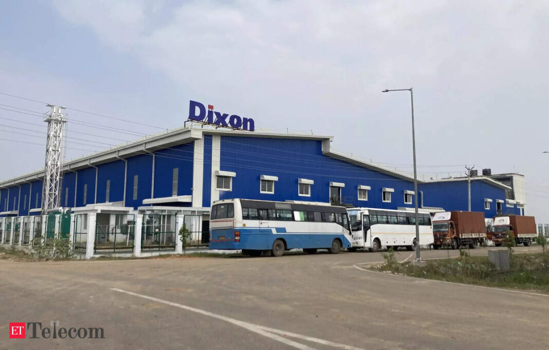 Dixon factory building exterior with buses and trucks parked.