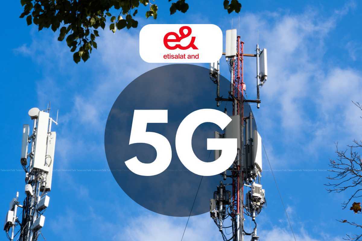 5G cellular network tower with company logo against sky.