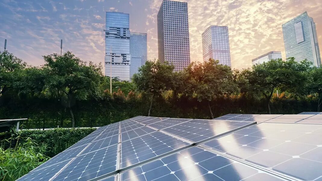 Solar panels with modern cityscape at sunset