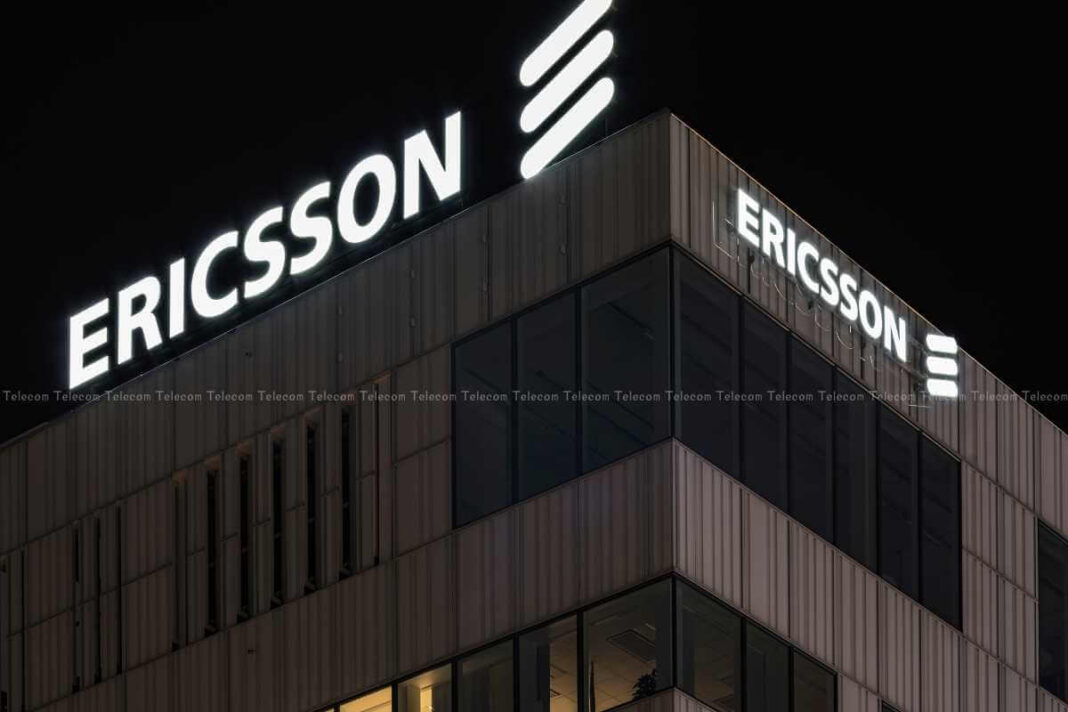 Illuminated Ericsson sign on building at night.