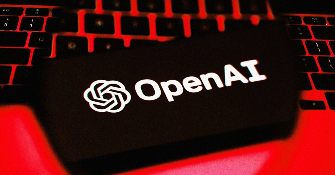 OpenAI logo on laptop screen in red lighting