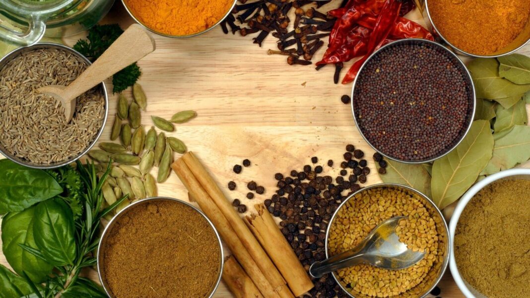 Assorted spices on wooden background for culinary seasoning
