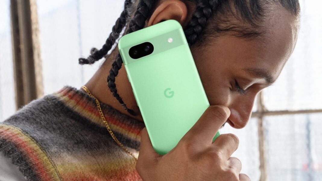 Person talking on mint-colored smartphone.