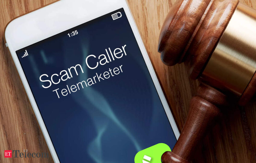 Phone displaying "Scam Caller Telemarketer" beside gavel.
