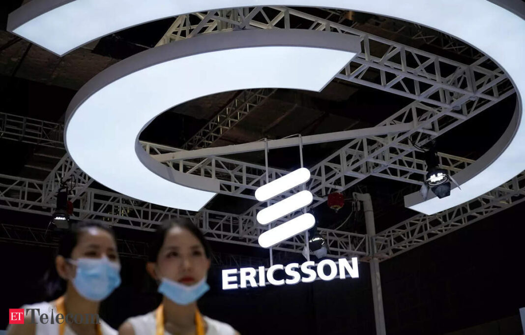 Ericsson logo displayed at trade fair with attendees.