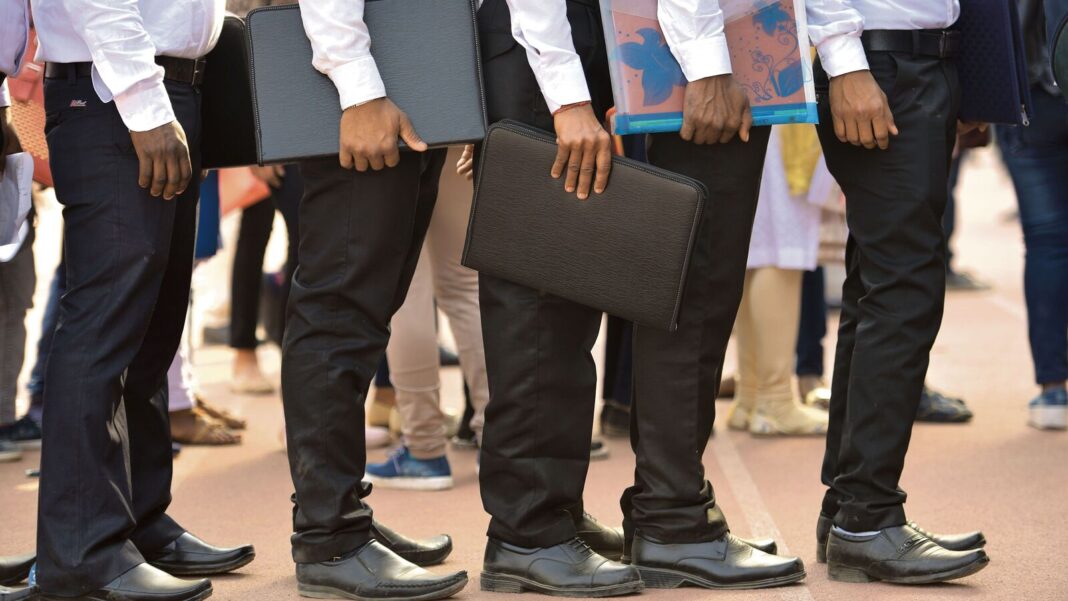 Group of professionals with briefcases standing in line.