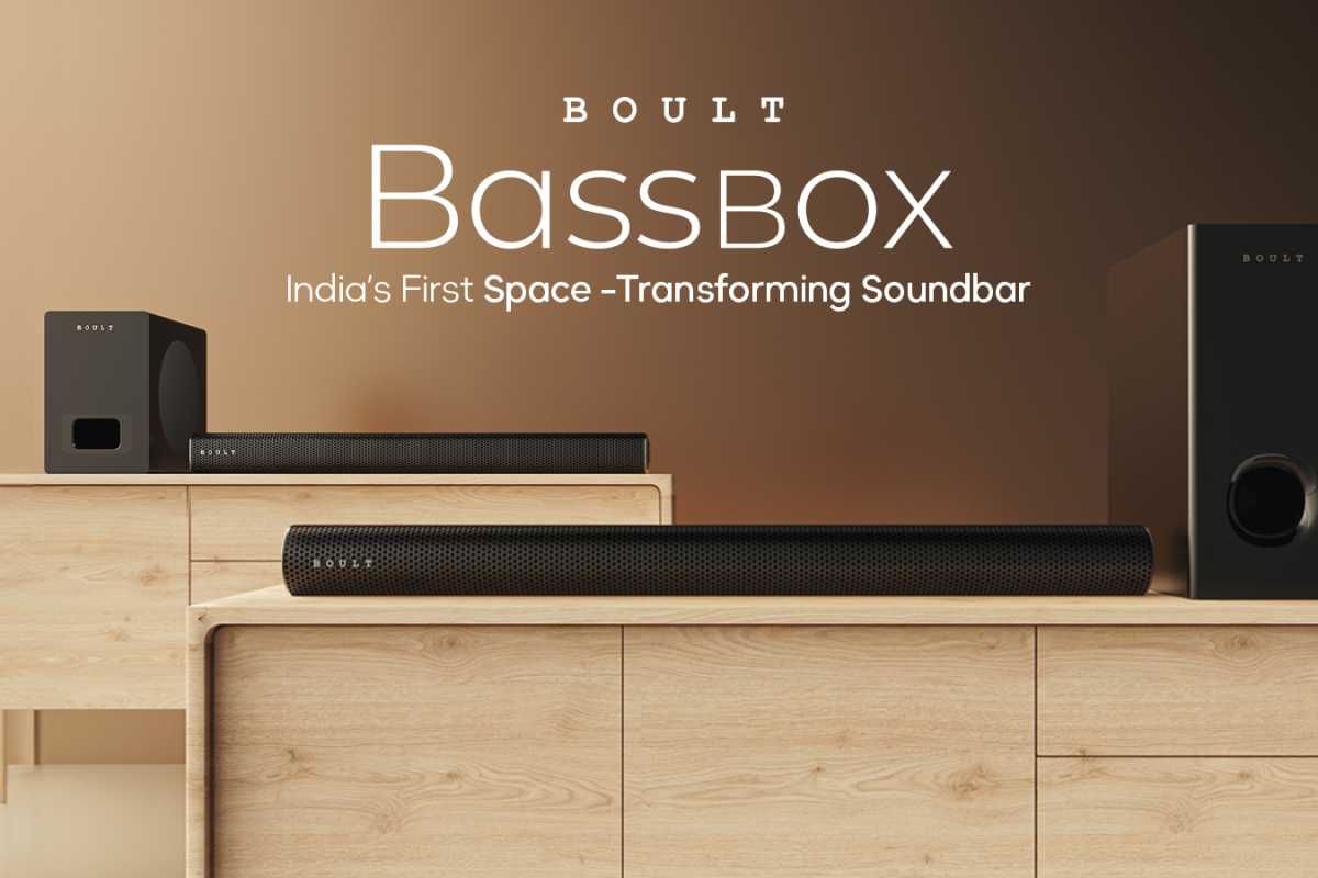 Boult BassBox soundbar advertisement on wooden furniture.